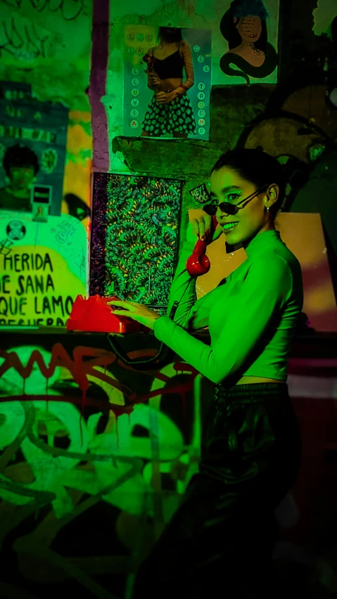 a young woman stands in a room with graffiti on the walls