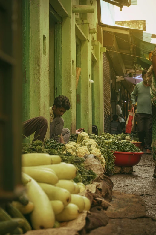 two people shopping at a market selling bananas and other vegetables