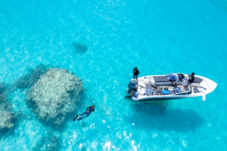 a man swimming and a boat on the ocean