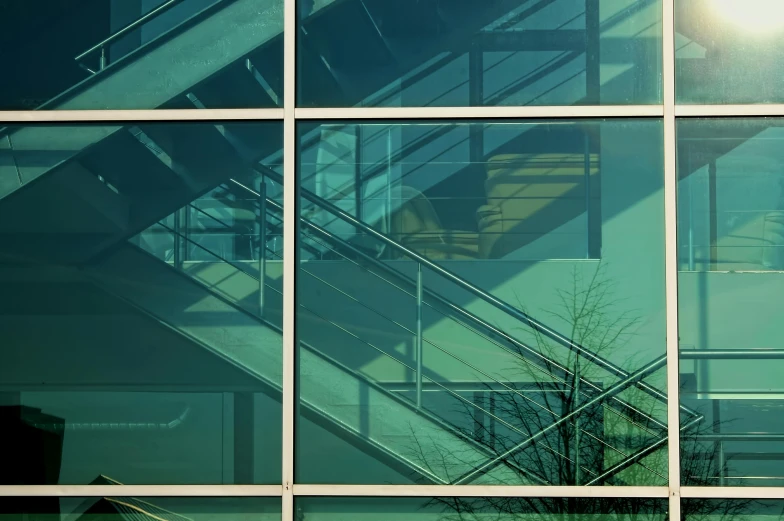 a po of stairs in front of glass windows