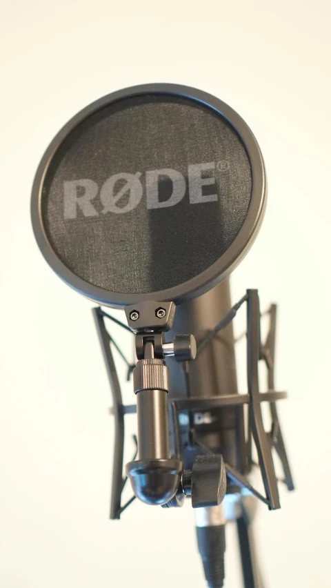 a large condensear microphone with the rode logo in white