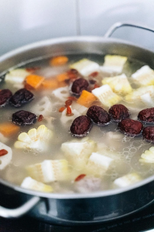 a pot of white and black food cooking on the stove