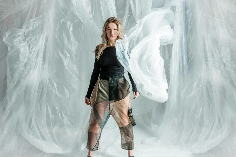 a woman standing in front of ice like background