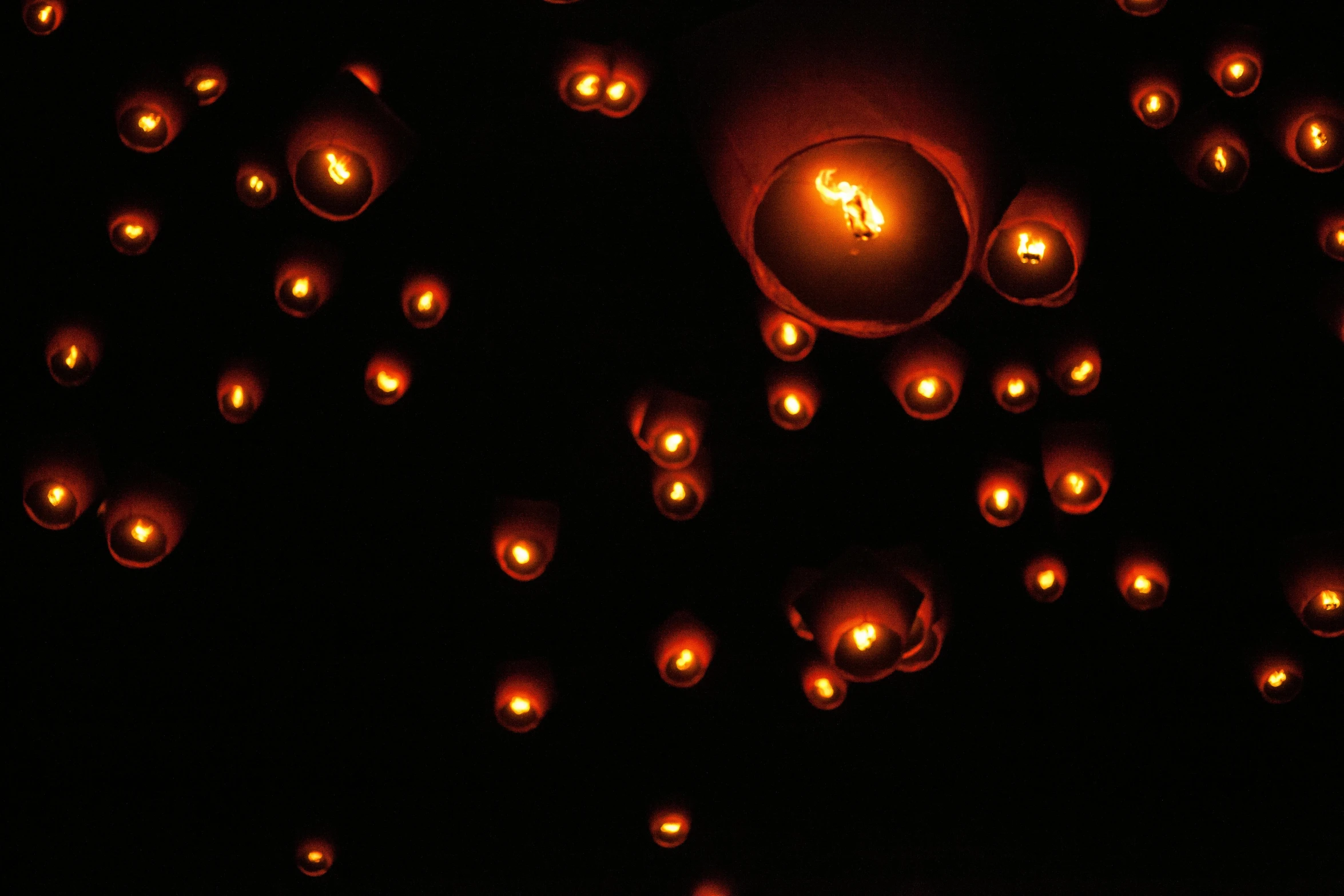 a group of lit up balls floating in the air