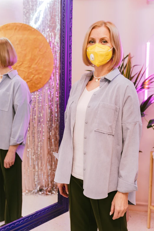 a woman with a dummy nose in front of a mirror