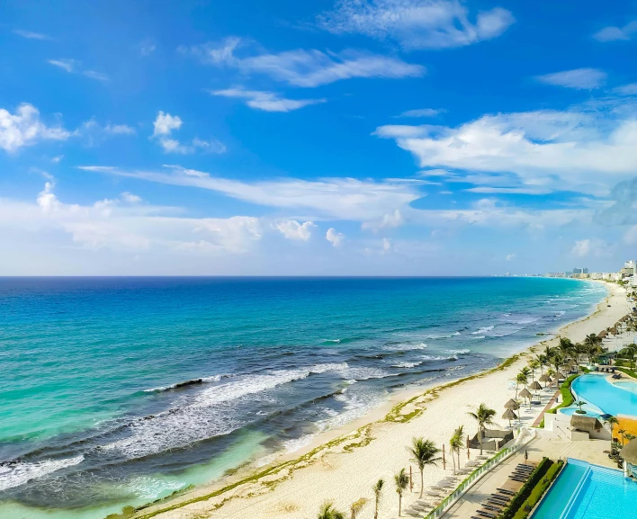 an aerial view of a large resort and the ocean