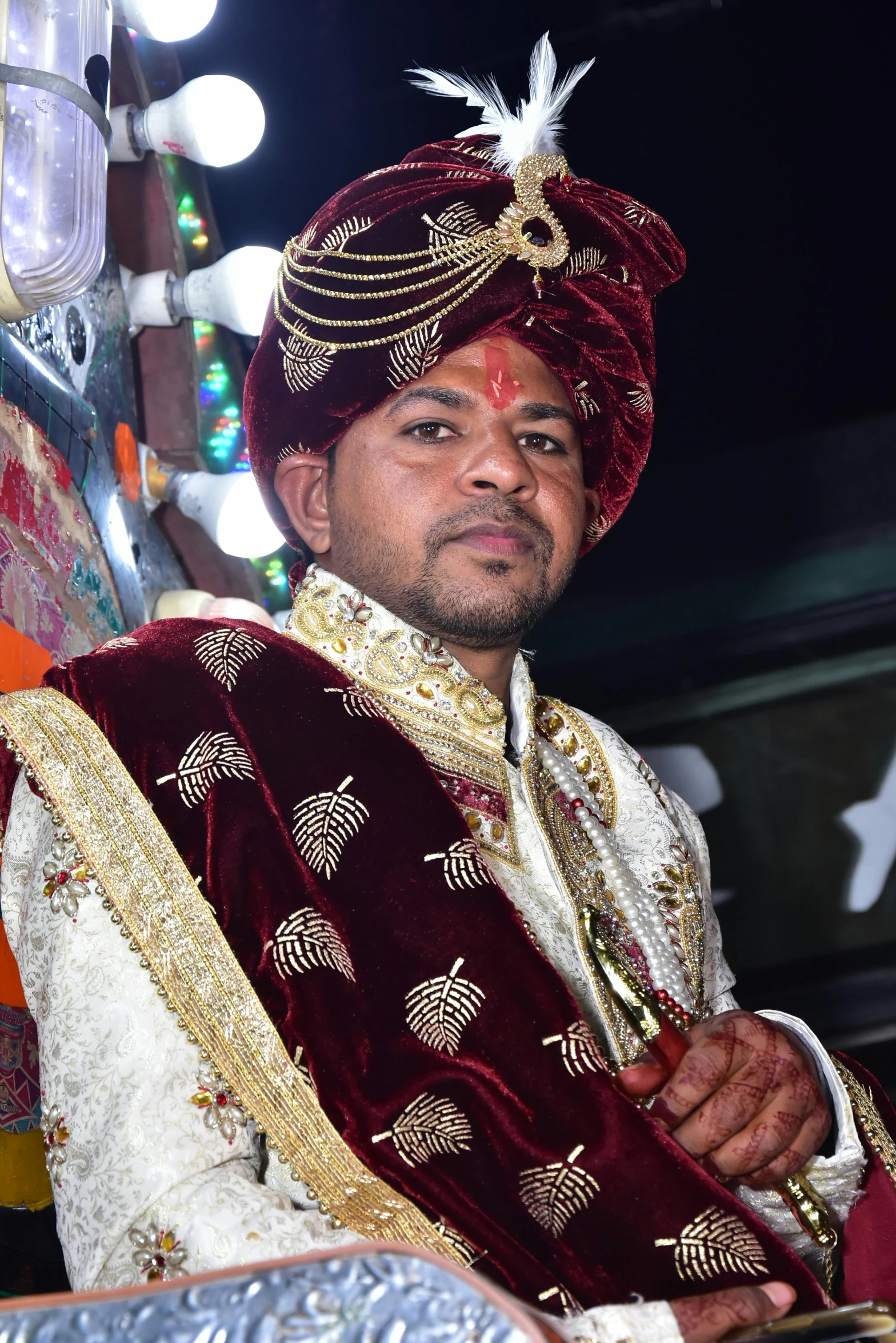 a man wearing a red and gold outfit posing for a po