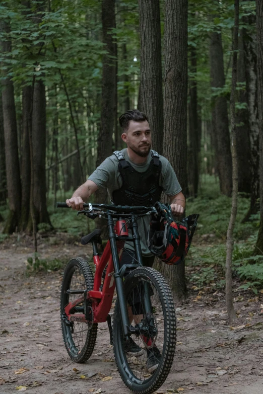 a man riding a bicycle down a dirt road