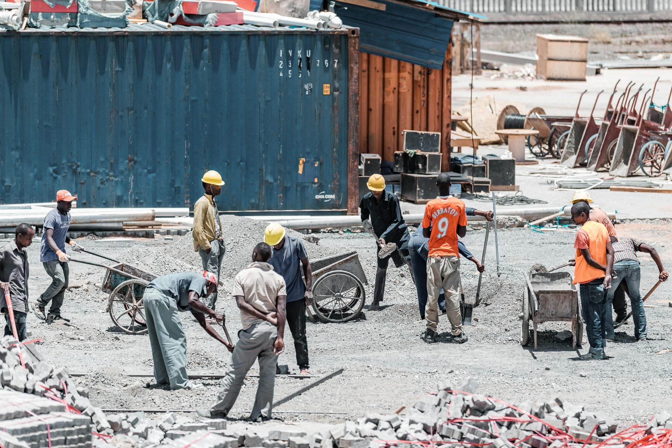 people with tools on a construction site working