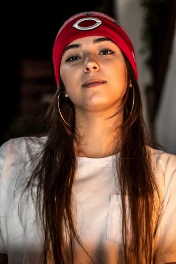 a woman with long hair and a red hat