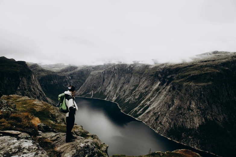 man overlooking the beautiful view in front of mountains