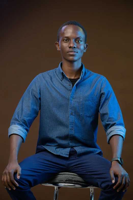 a man is sitting down and posing