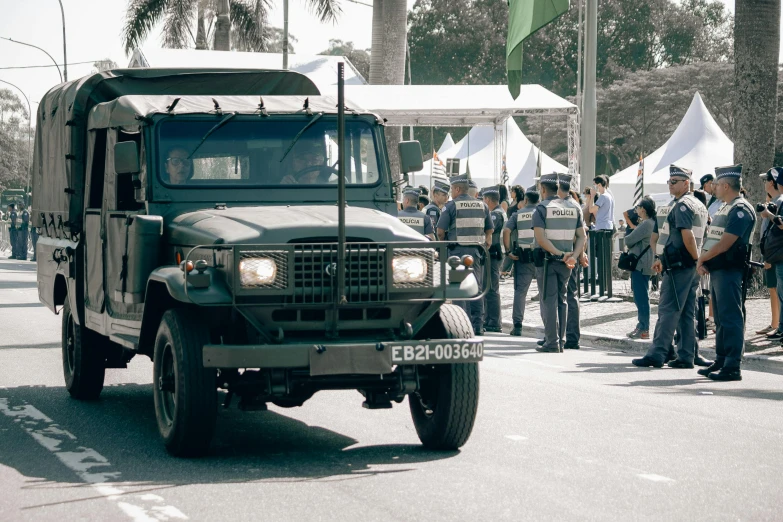 people are standing in line to get a military truck