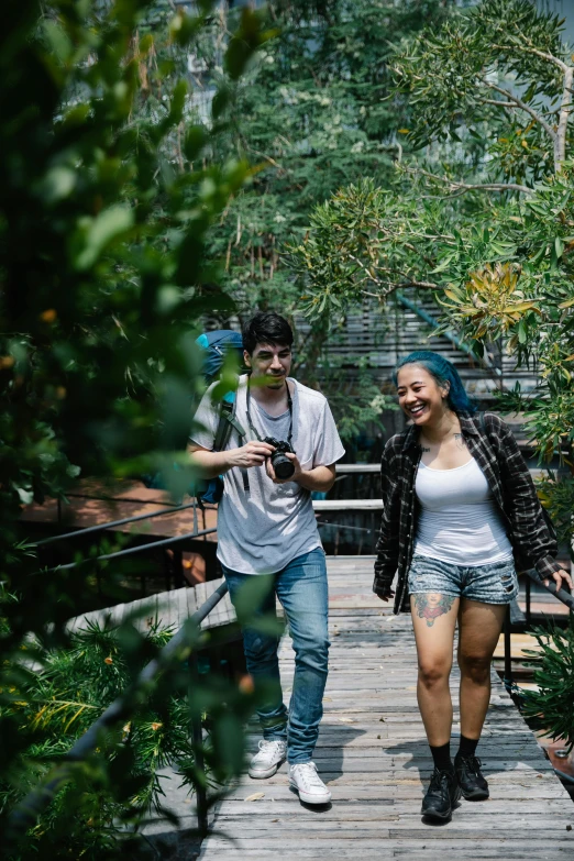 two people standing on a bridge and taking a po