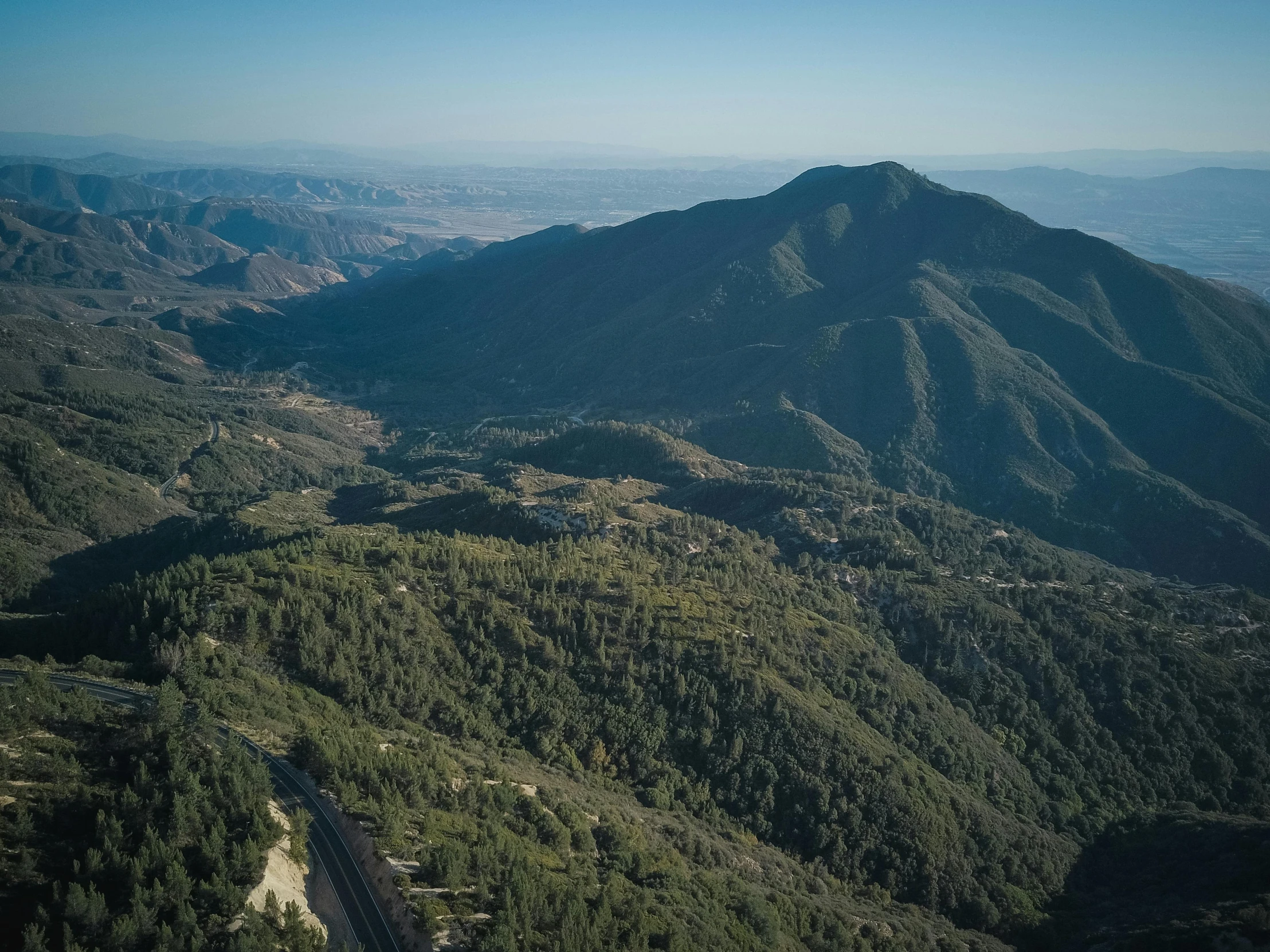 an aerial view of the mountains and a highway