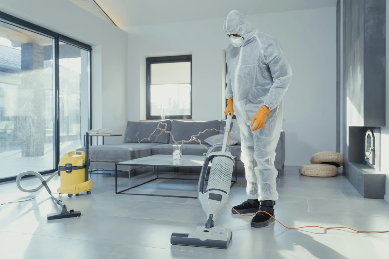 a man with a mop standing in a room