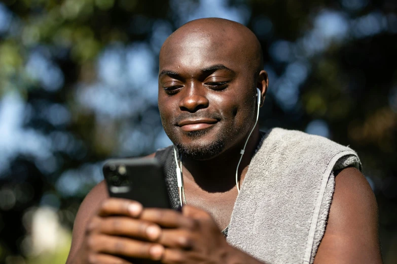 a man in headphones looking at his cellphone