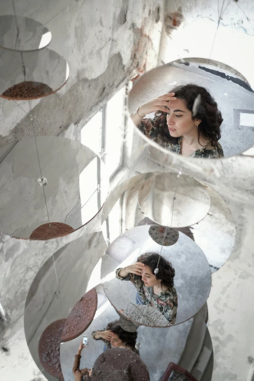 a woman in the reflection of three mirrors