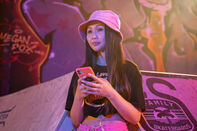 girl in front of graffiti wall using a cell phone