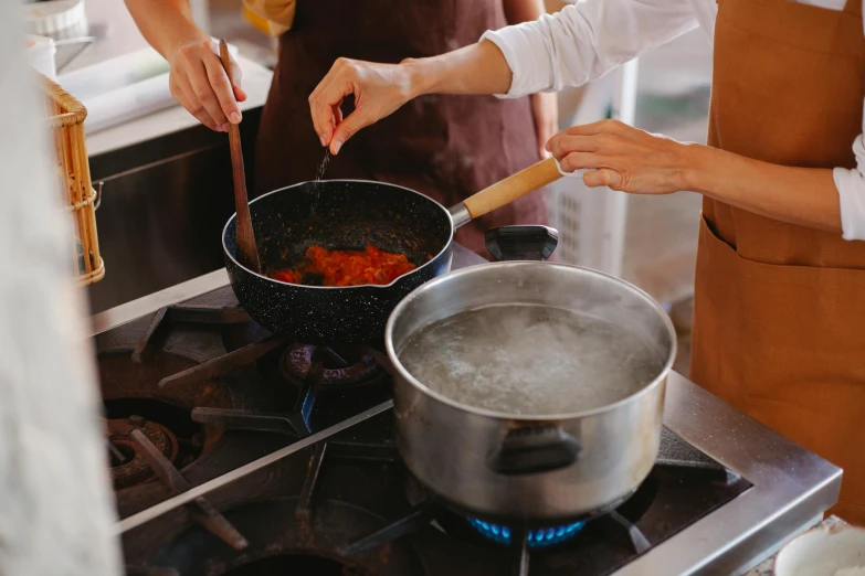 two women are preparing food at the kitchen