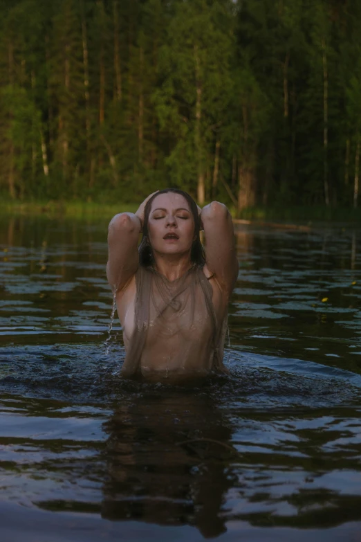 a woman wearing a head scarf in the water