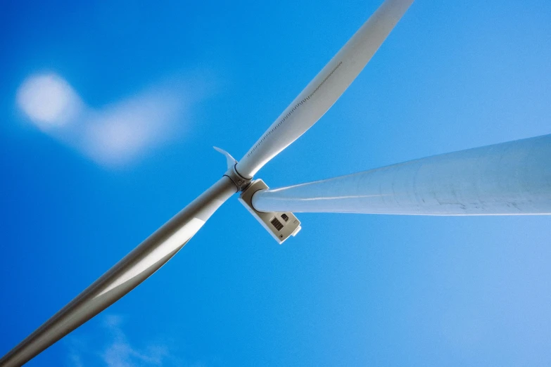 the blades of a wind turbine are visible in the sky