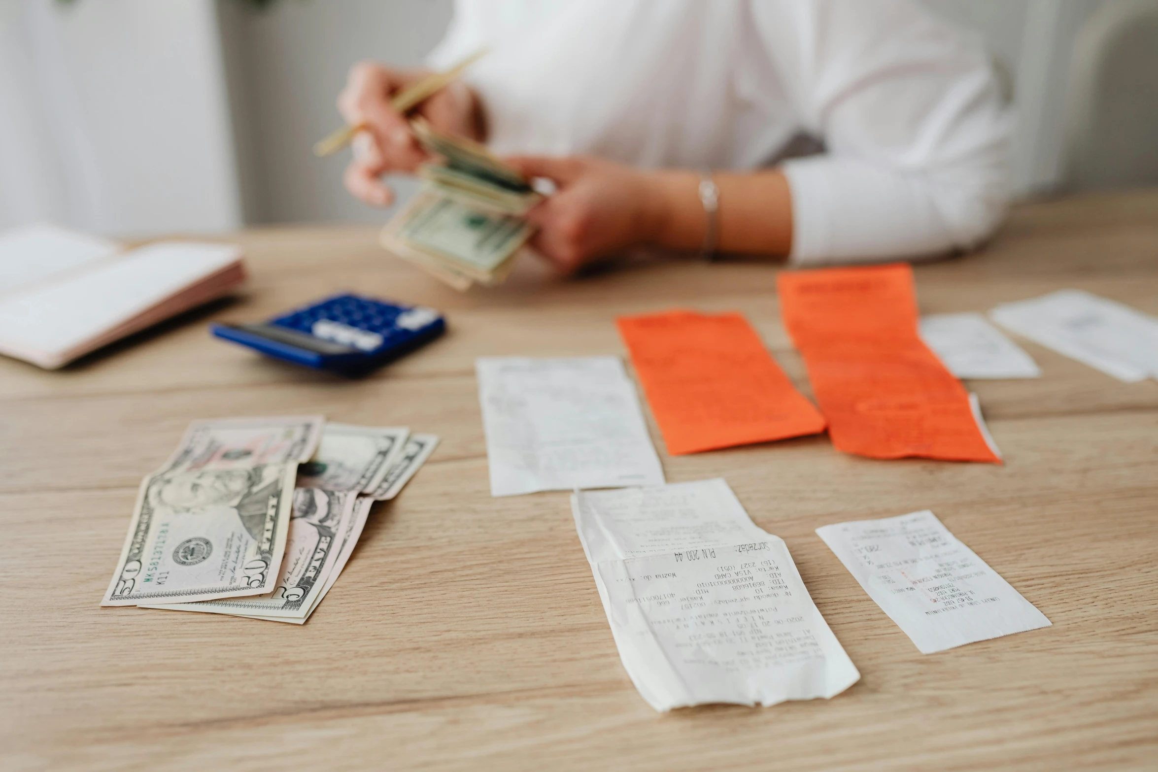 money notes and money bills are strewn across a table