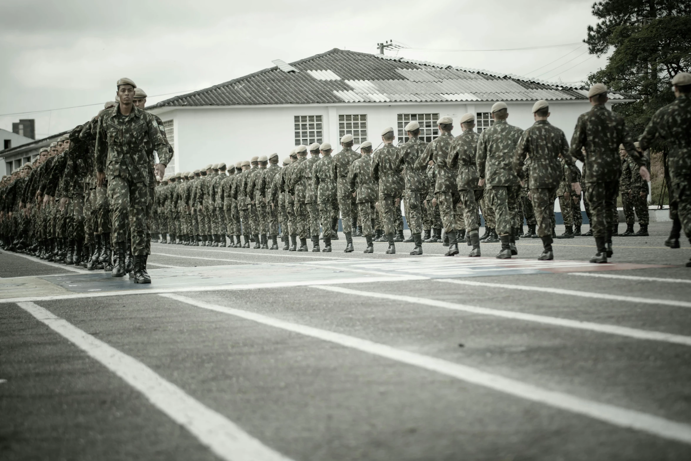 a military color guard watches over a line of soldiers