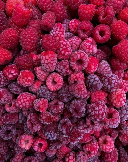 a close up view of raspberries on a table
