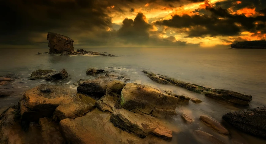 a rock outcropping in the middle of the ocean on top of water