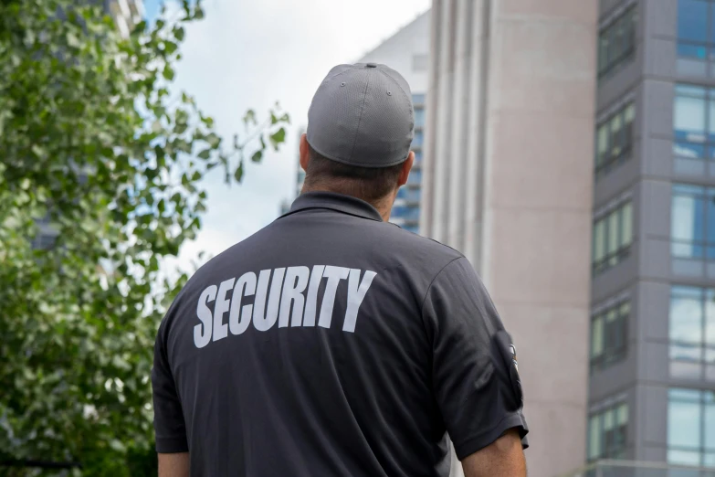 the security officer is looking up at the building