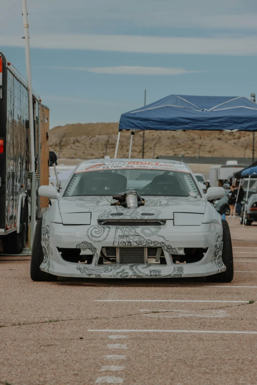 a white car with an all over decals on it