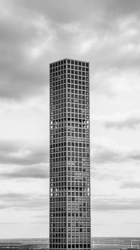 an apartment building with lots of windows near a large body of water