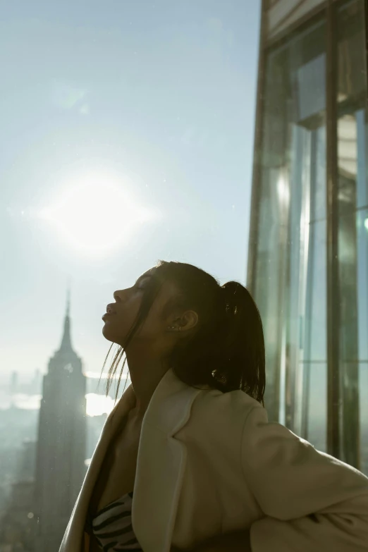 woman looking down from window in large office building