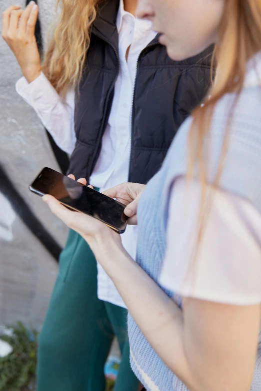 two people holding their cell phones together