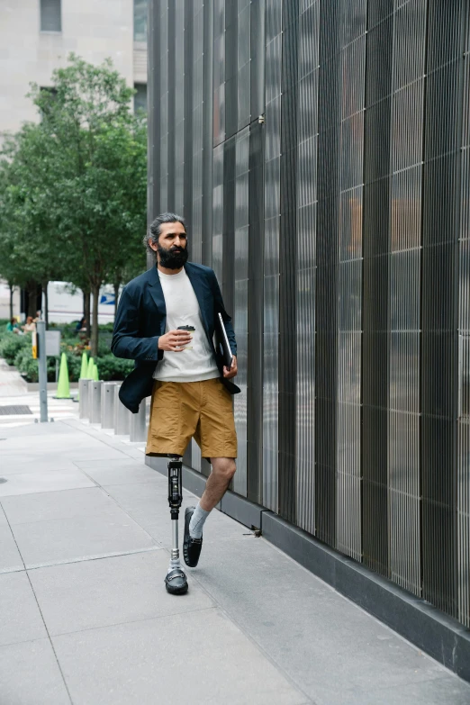 a bearded man walking down the sidewalk wearing black boots