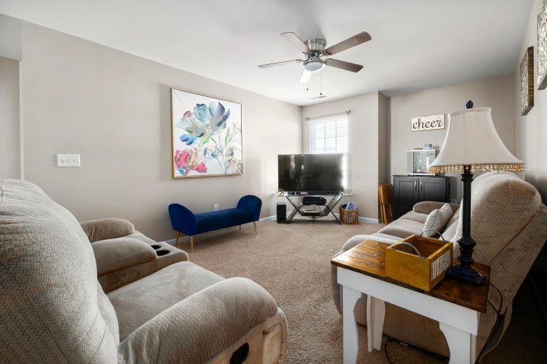 living room with couches, chair and television