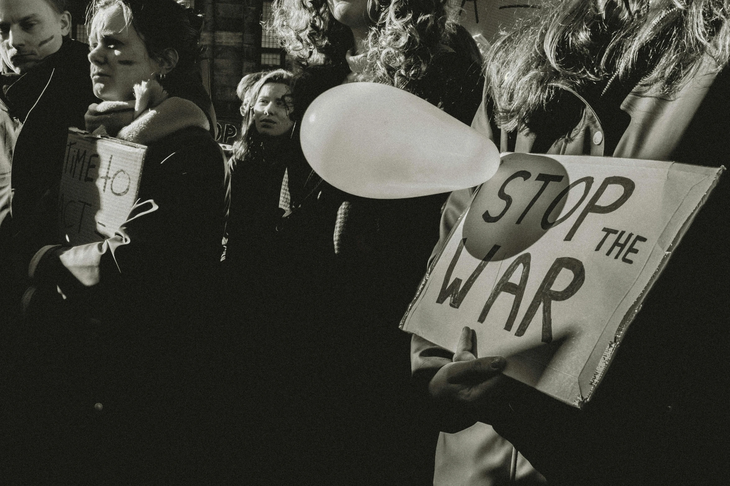 some people with white hats on holding a sign