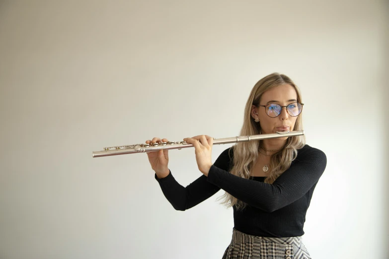 a beautiful blonde in a skirt holding a musical instrument