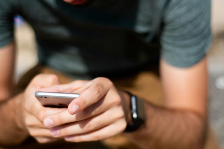 a man checking his cellphone with his finger