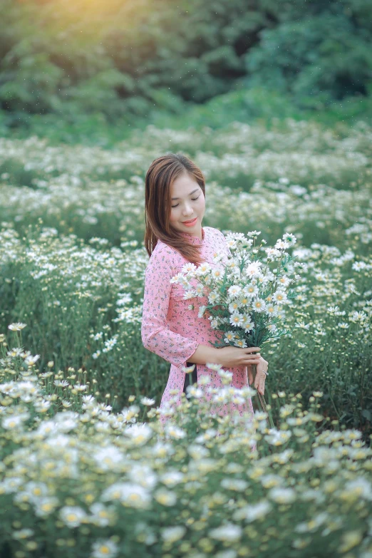 the woman stands in a flower meadow