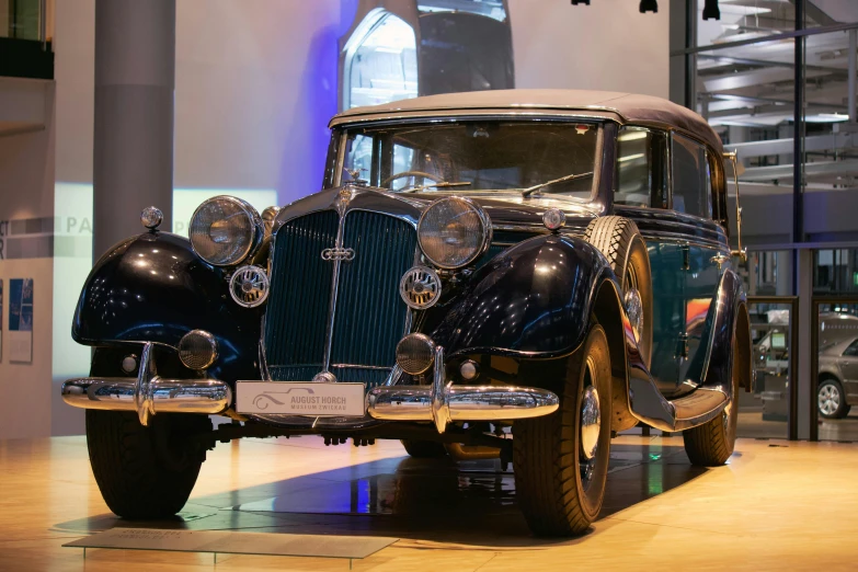 an old classic car on display at a museum