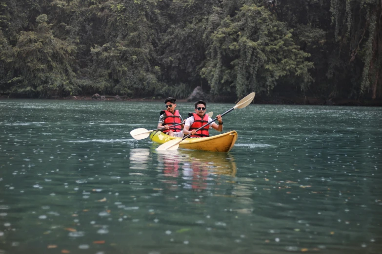 two people in a canoe paddling down the river