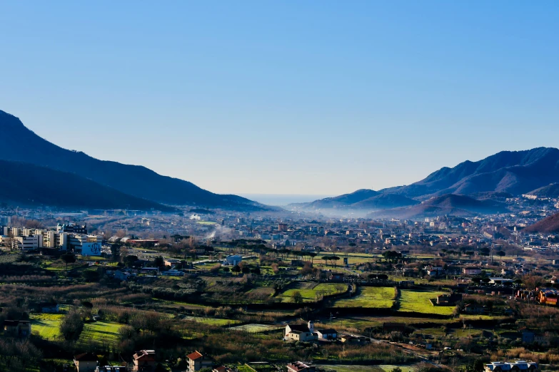 small village surrounded by large hills in the distance