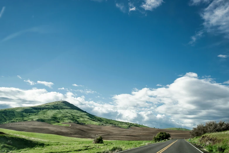 a highway with a few hills in the background