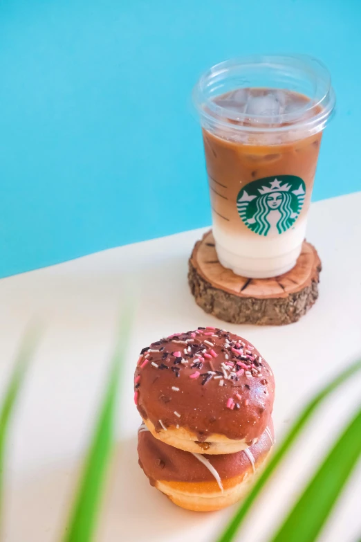 a doughnut sitting on a coaster next to a cup of coffee