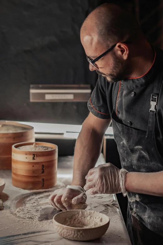 a chef scooping some flour onto a brown bowl