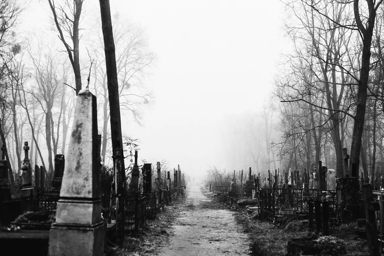 a dark, lonely cemetery with tombstones at the end