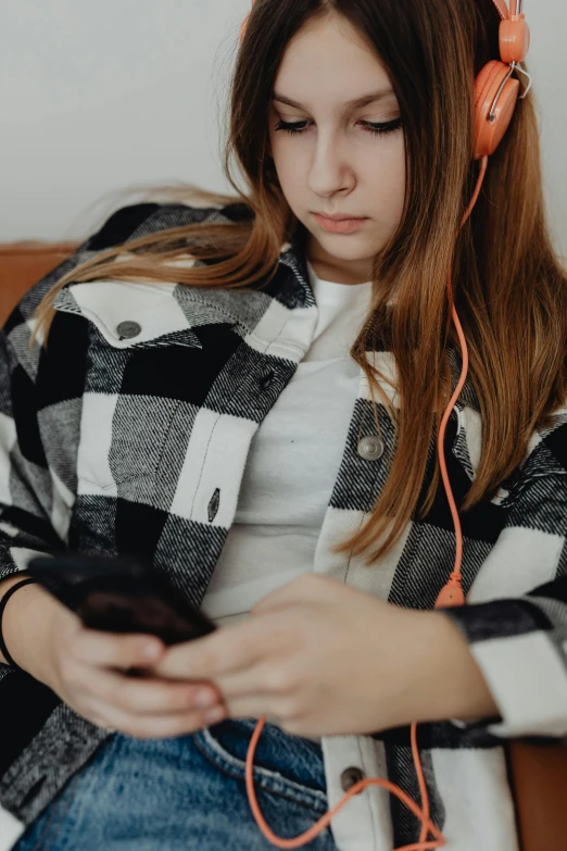 a woman sitting on a couch looking at her phone