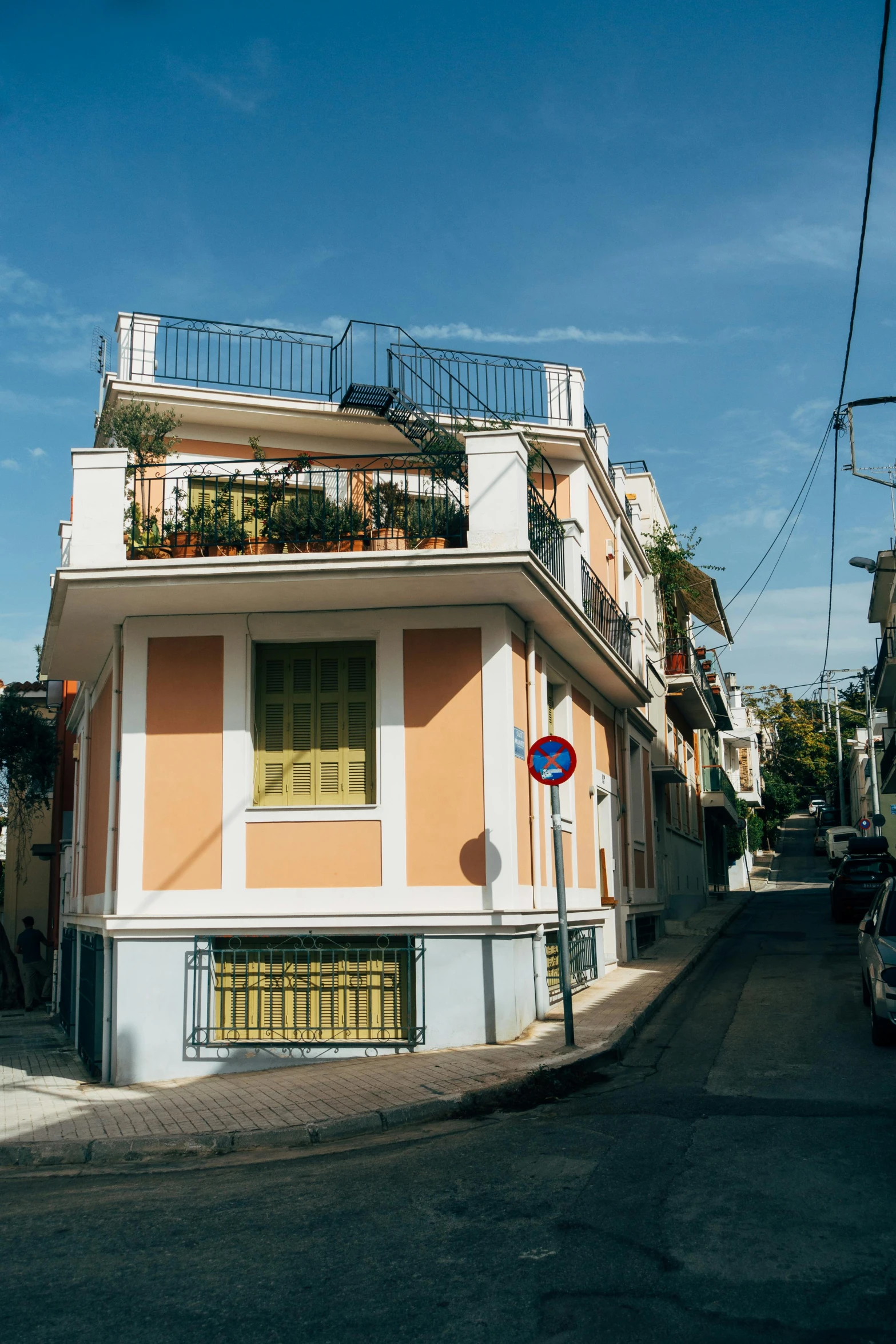 an orange and white building sitting on the side of a road